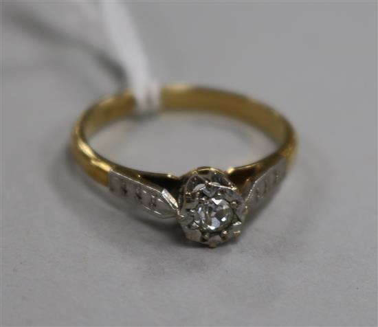 An 18ct gold and platinum illusion set solitaire diamond ring, size N.